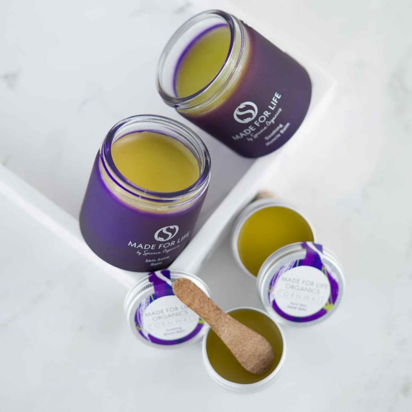 yellow balm in purple jars for Made For Life ORganics First Aid Kit balms